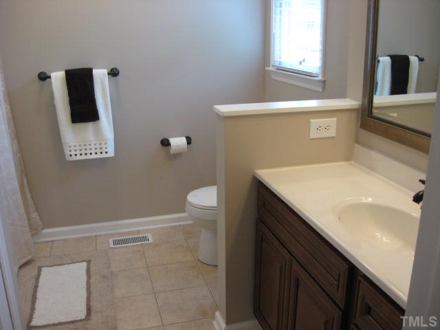 4000 Old Coach Road Raleigh, NC 27616 - Photo 10 of 12 a bathroom with a sink a toilet and mirror
