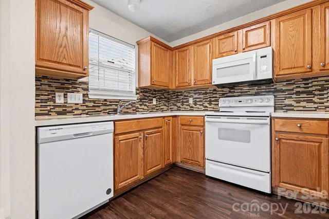 a kitchen with granite countertop cabinets stainless steel appliances and a sink