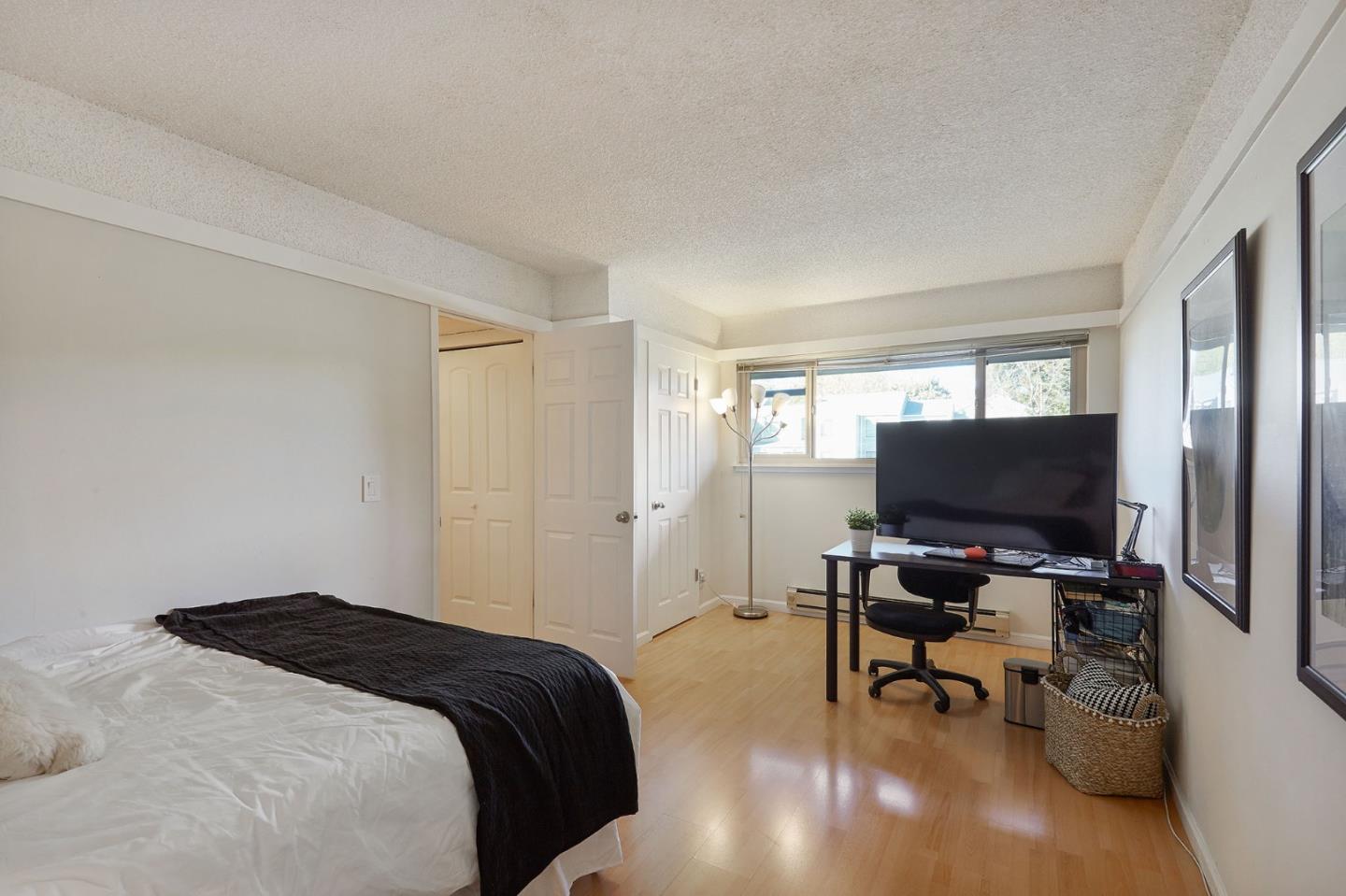 500 West Middlefield Road, Unit 93 Mountain View, CA 94043 - Photo 13 of 29 a bedroom with a bed and a flat screen tv