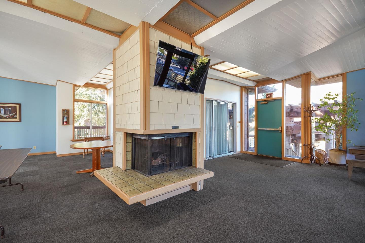 500 West Middlefield Road, Unit 93 Mountain View, CA 94043 - Photo 24 of 29 a bedroom with furniture and a fireplace