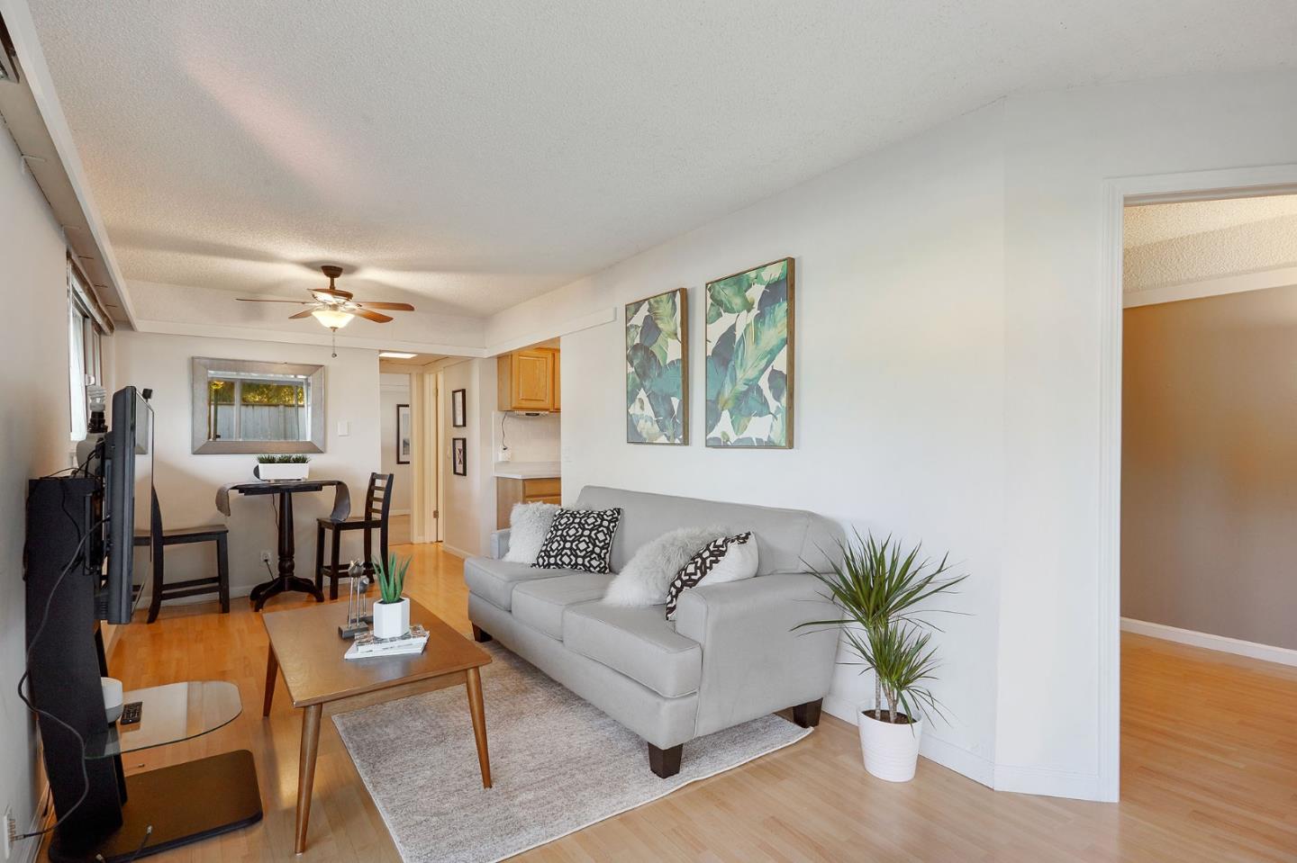 500 West Middlefield Road, Unit 93 Mountain View, CA 94043 - Photo 3 of 29 a living room with furniture and a potted plant