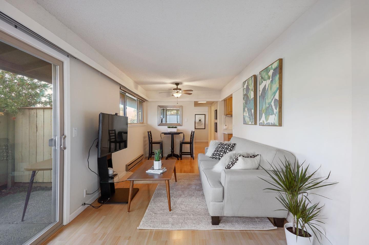 500 West Middlefield Road, Unit 93 Mountain View, CA 94043 - Photo 4 of 29 a living room with furniture large window and wooden floor