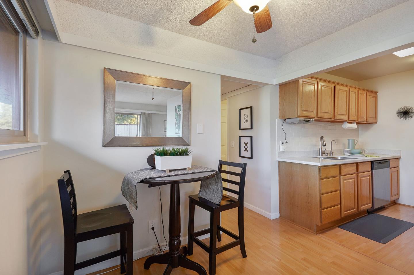 500 West Middlefield Road, Unit 93 Mountain View, CA 94043 - Photo 6 of 29 a kitchen with stainless steel appliances kitchen island a table chairs in it and wooden floors