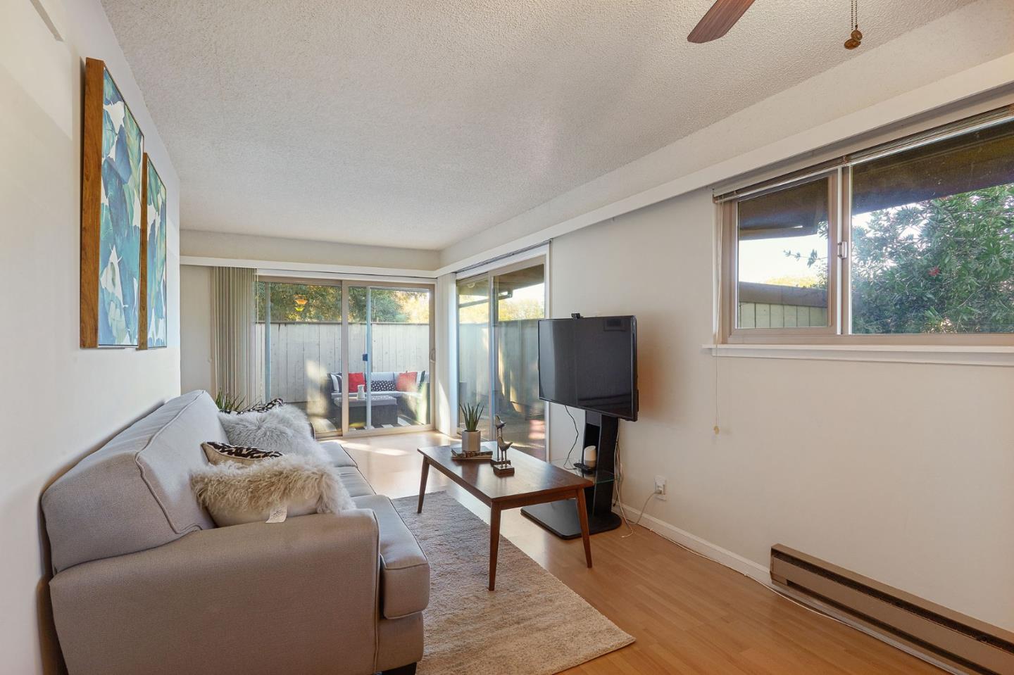 500 West Middlefield Road, Unit 93 Mountain View, CA 94043 - Photo 7 of 29 a living room with furniture and a flat screen tv