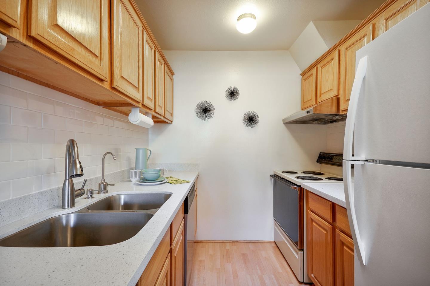 500 West Middlefield Road, Unit 93 Mountain View, CA 94043 - Photo 8 of 29 a kitchen with stainless steel appliances granite countertop a sink stove and refrigerator