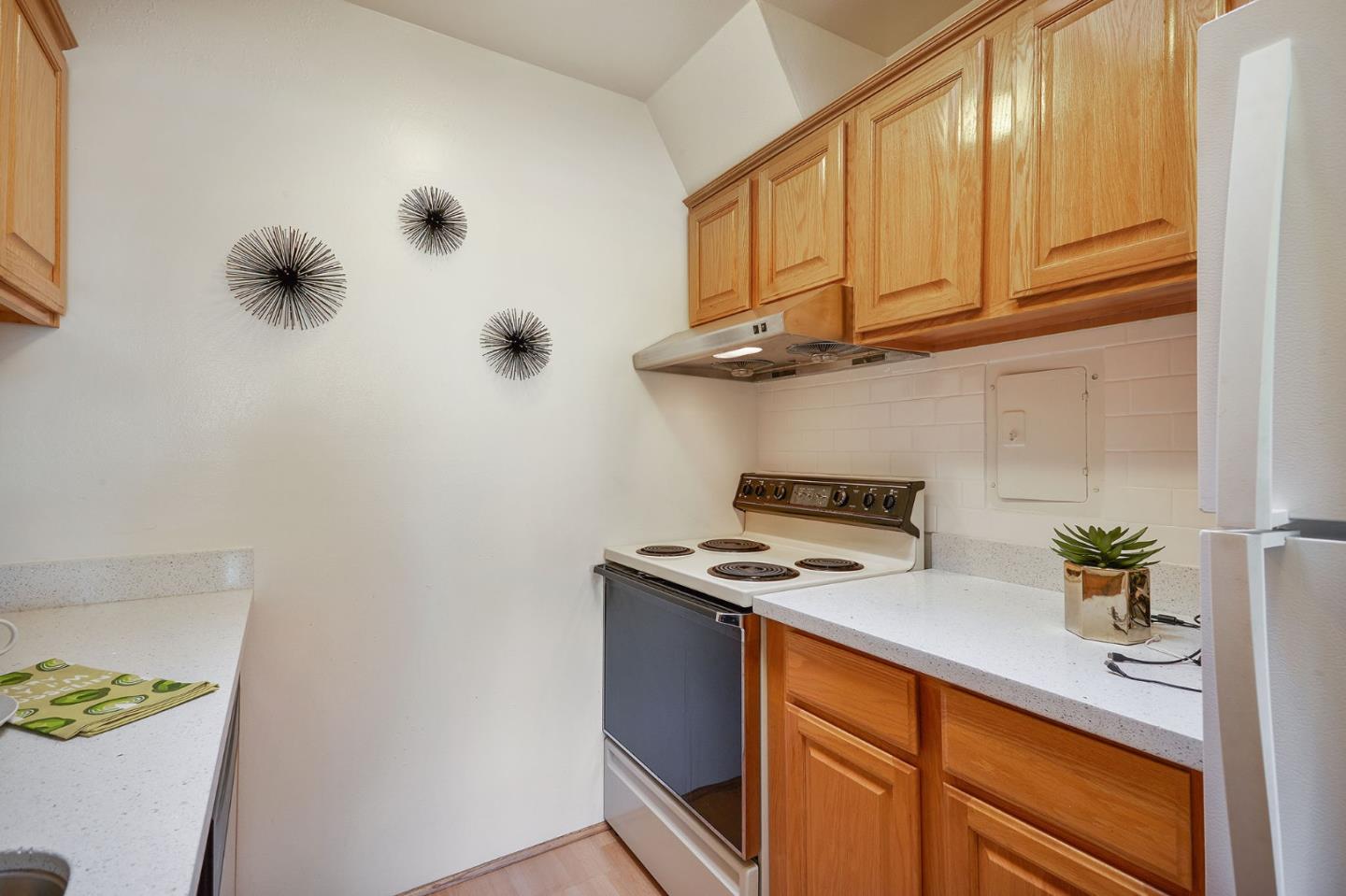 500 West Middlefield Road, Unit 93 Mountain View, CA 94043 - Photo 10 of 29 a kitchen with stainless steel appliances granite countertop a stove a sink and a microwave