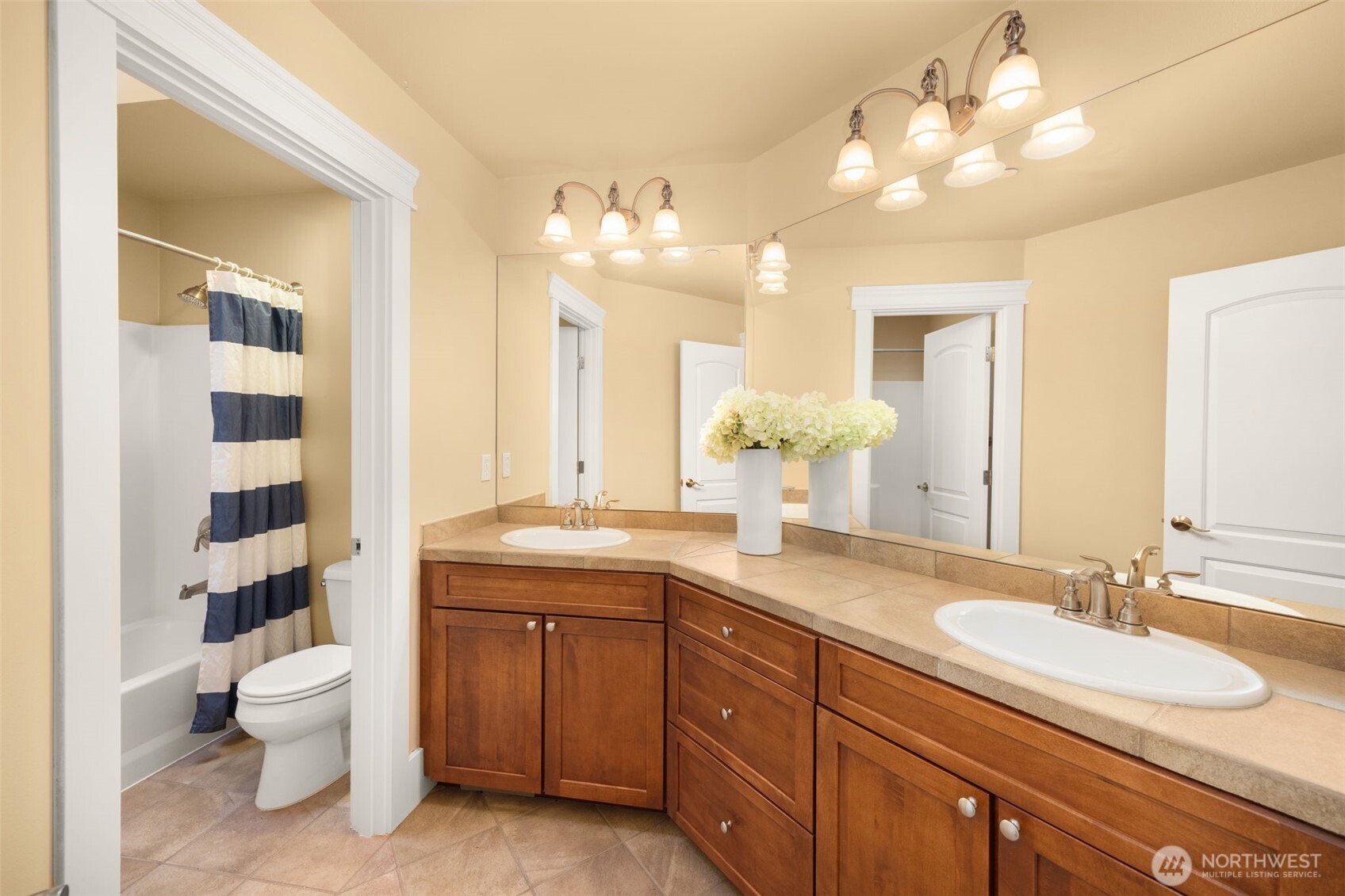 18638 92nd Avenue Northeast Bothell, WA 98011 - Photo 35 of 40 a bathroom with a sink a toilet and a large mirror