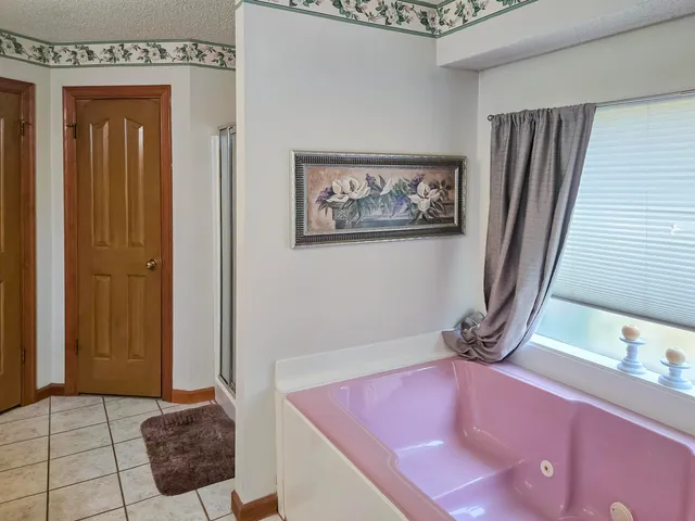 a en suite bathroom with a granite countertop sink and a mirror