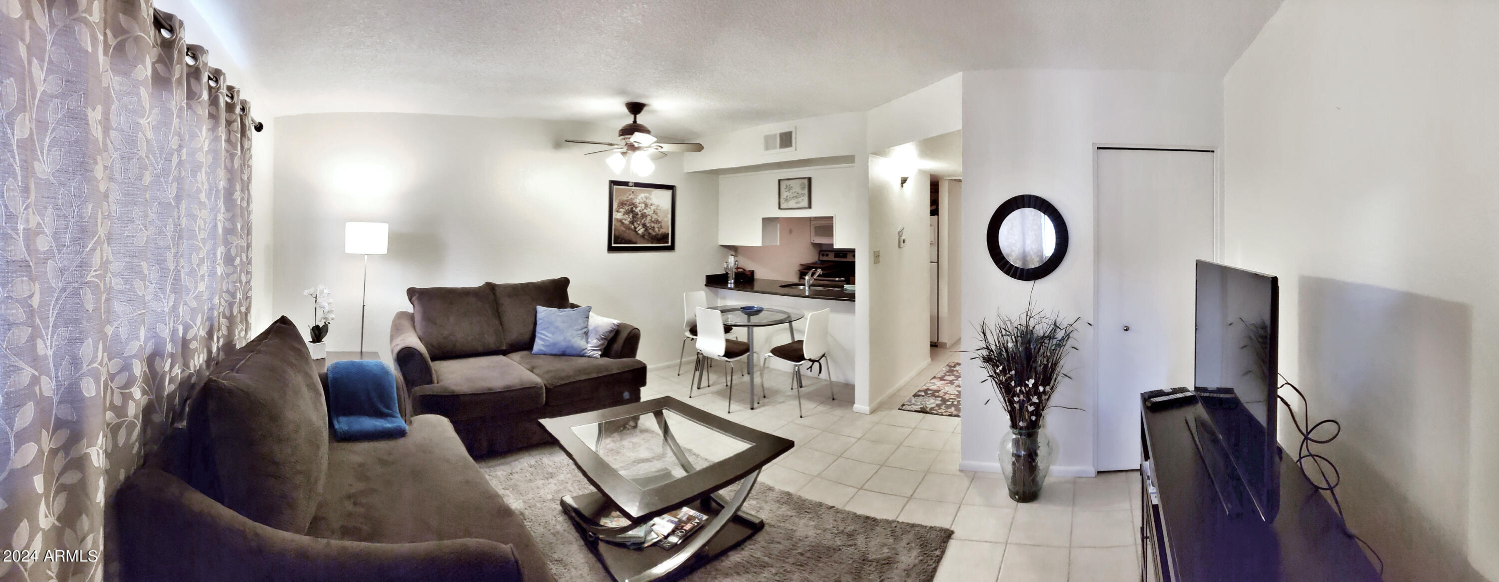 7436 East Chaparral Road, Unit 120B Scottsdale, AZ 85250 - Photo 1 of 24 a living room with furniture a clock on wall and a window