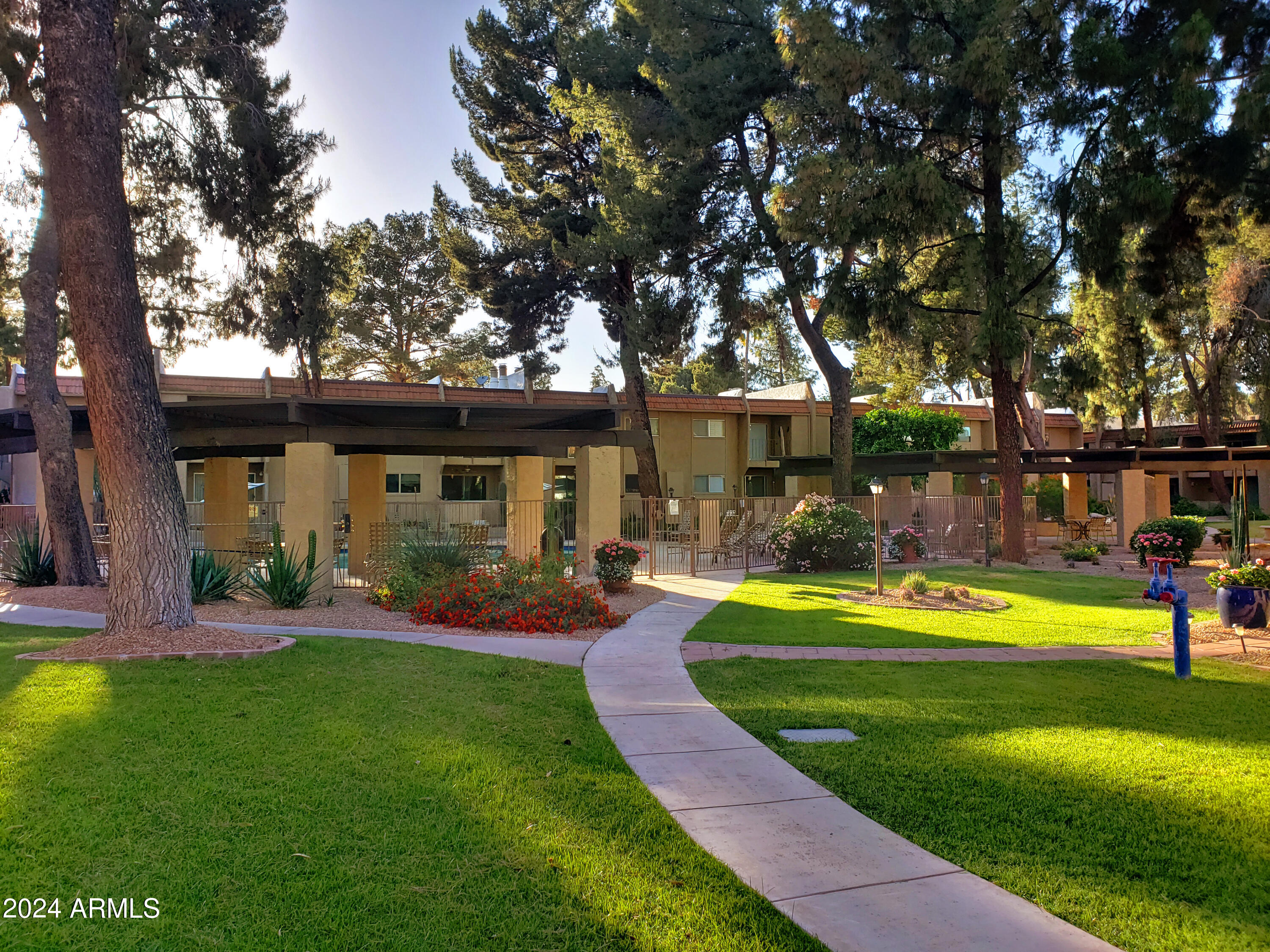 7436 East Chaparral Road, Unit 120B Scottsdale, AZ 85250 - Photo 17 of 24 a view of a house with swimming pool and a yard