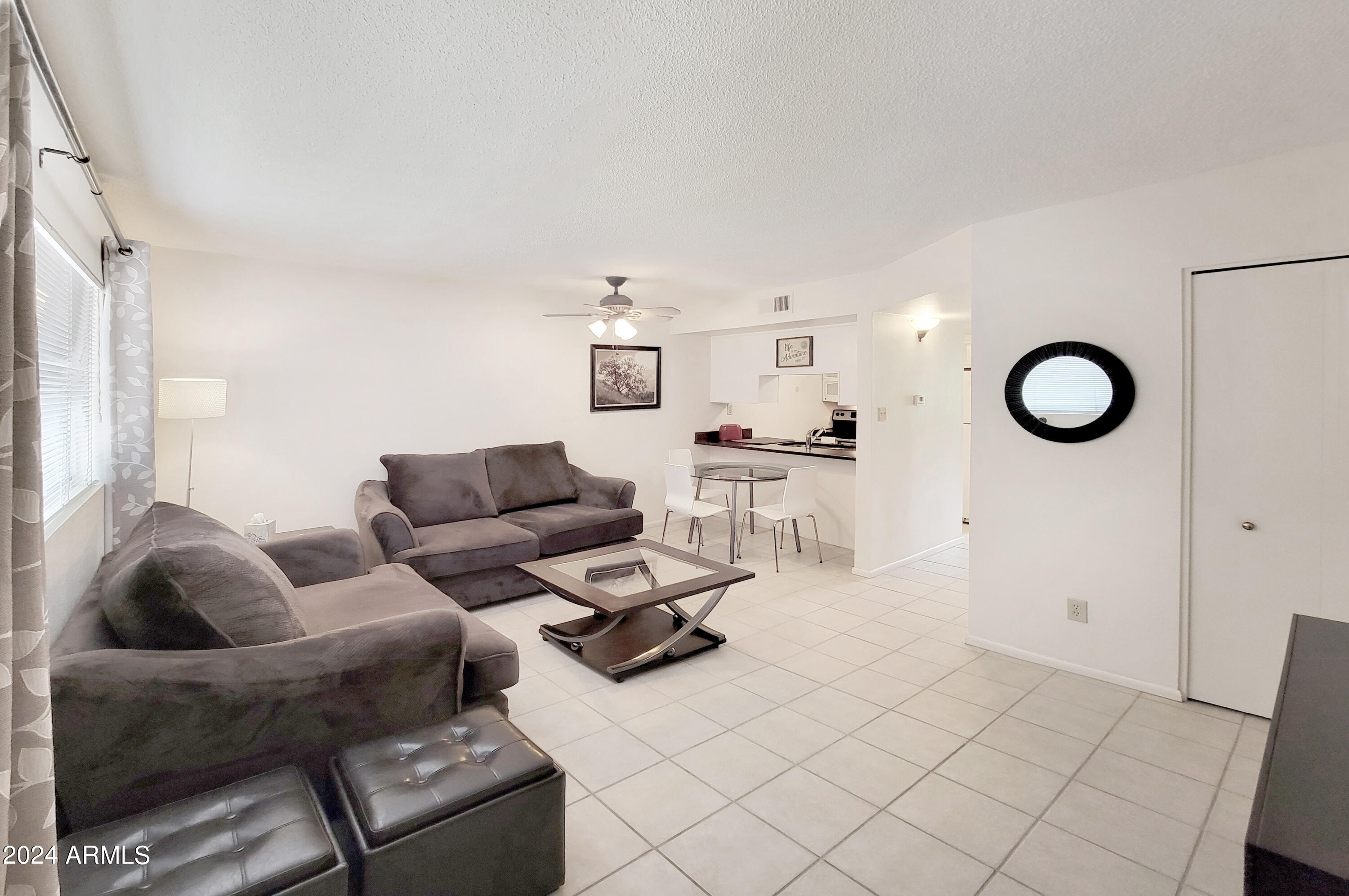 7436 East Chaparral Road, Unit 120B Scottsdale, AZ 85250 - Photo 3 of 24 a living room with furniture and a large window