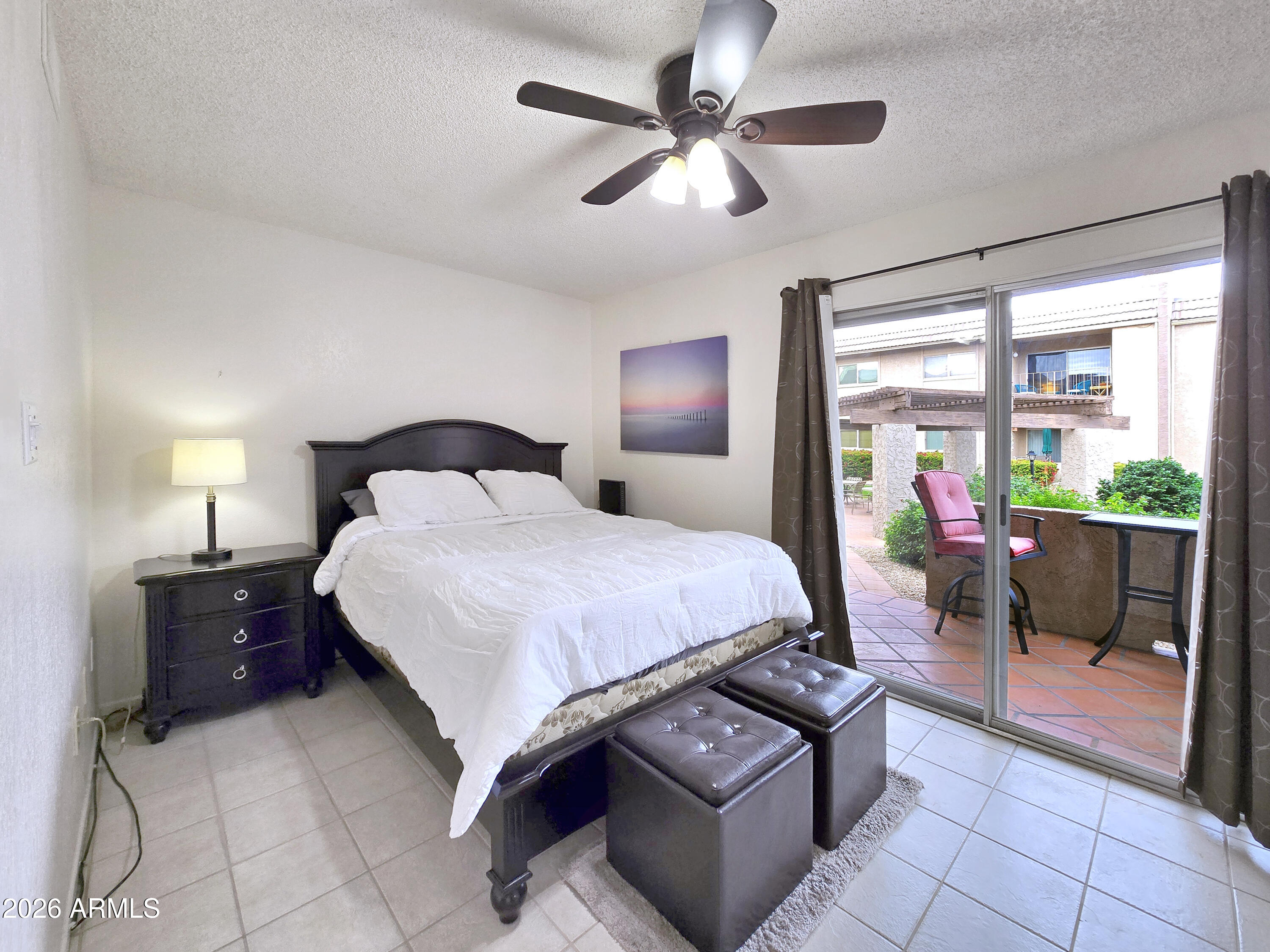 7436 East Chaparral Road, Unit 120B Scottsdale, AZ 85250 - Photo 8 of 24 a bedroom with a bed a couch and a chandelier