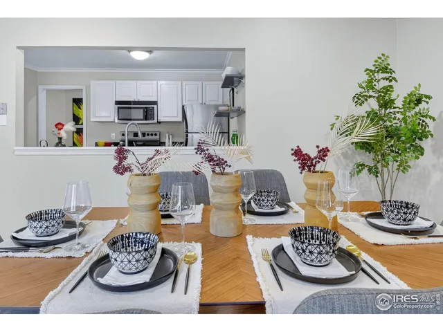 a kitchen with a table and stove top oven