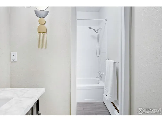 a bathroom with a granite countertop sink a toilet and shower