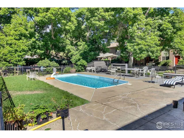 a view of a swimming pool with an outdoor space and seating area