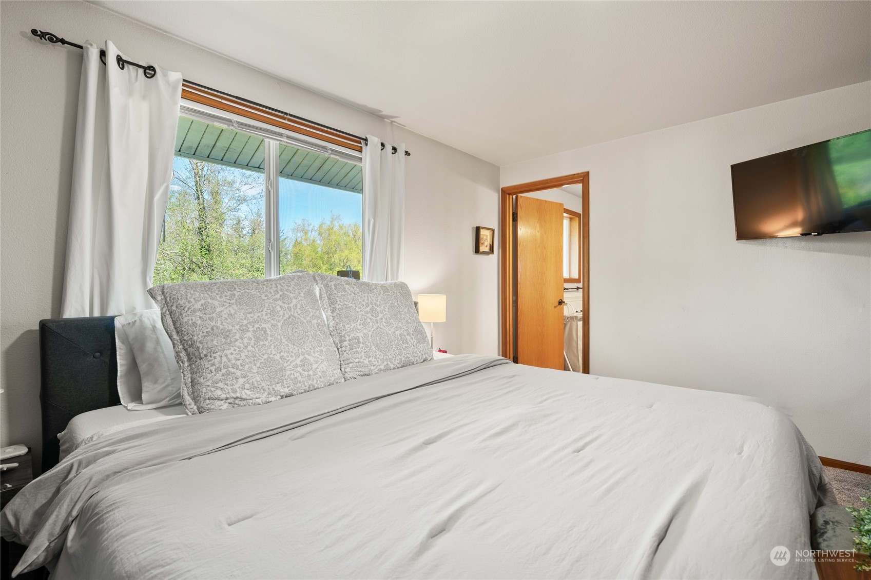 323 Edgewater Lane Lynden, WA 98264 - Photo 17 of 40 a large bed sitting in a bedroom next to a window