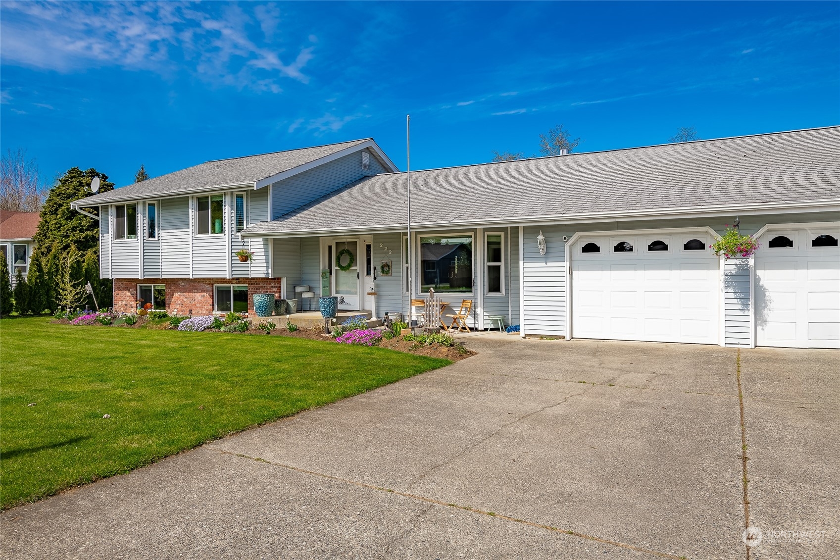 323 Edgewater Lane Lynden, WA 98264 - Photo 2 of 40 a view of a house with a garden and pathway