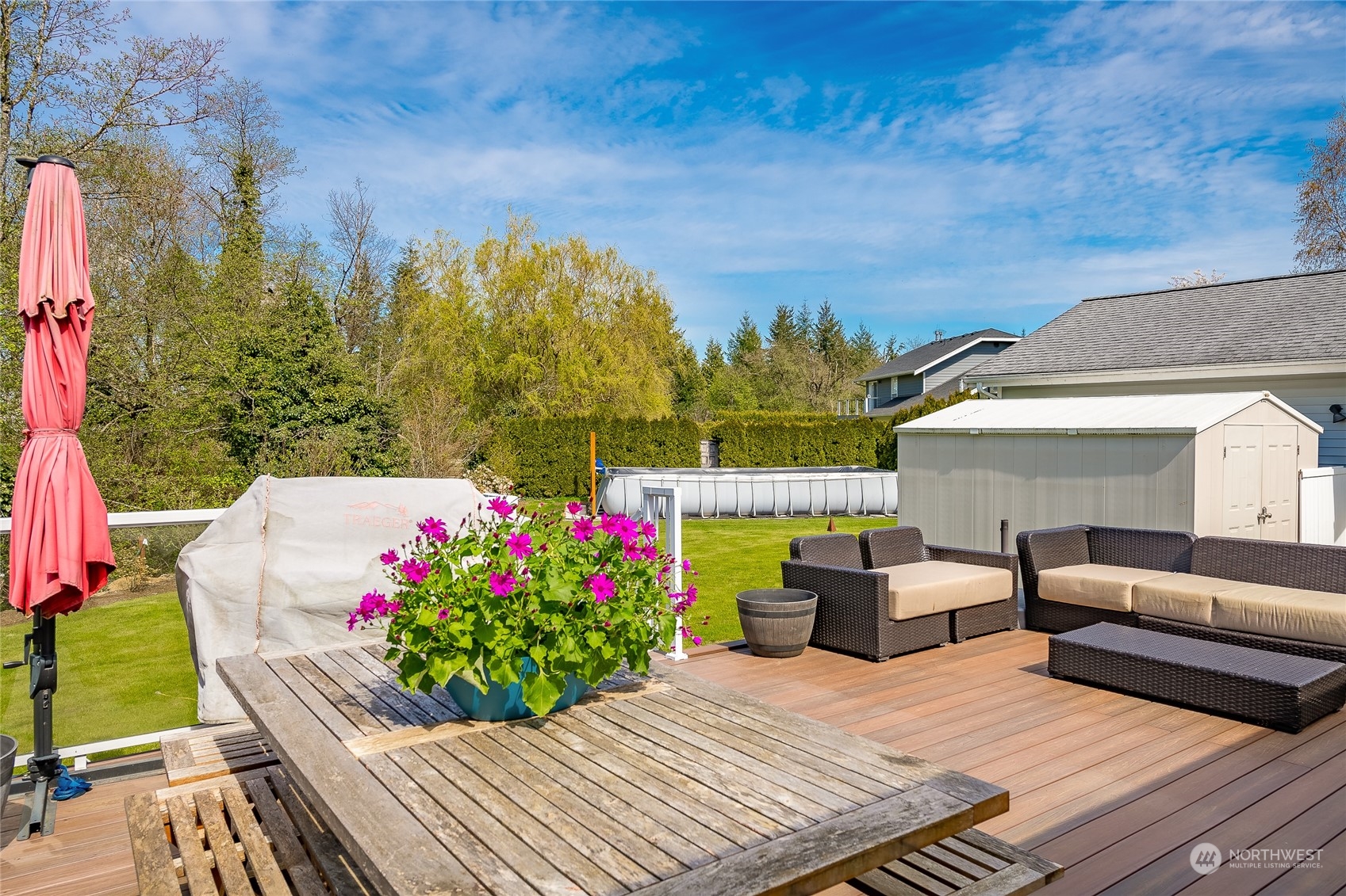 323 Edgewater Lane Lynden, WA 98264 - Photo 25 of 40 a view of a patio with couches and table and chairs and potted plants