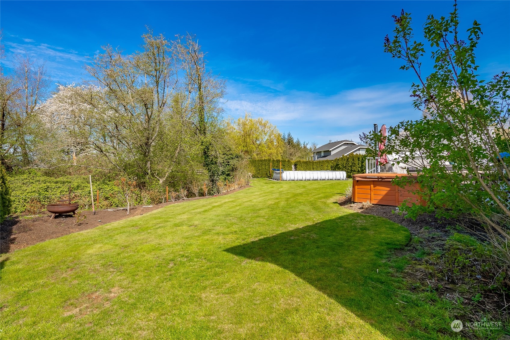 323 Edgewater Lane Lynden, WA 98264 - Photo 36 of 40 a view of yard with swimming pool and trees