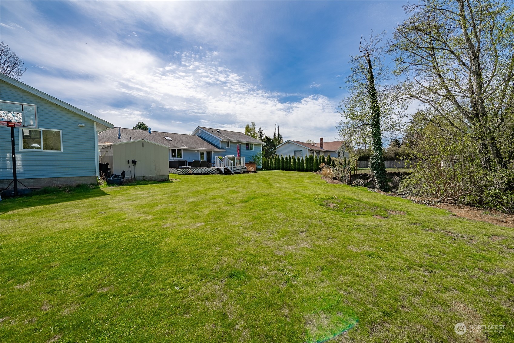323 Edgewater Lane Lynden, WA 98264 - Photo 38 of 40 a view of a patio with table and chairs under an umbrella