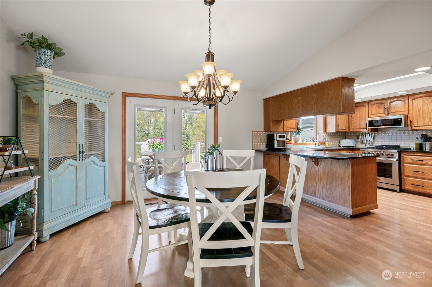 323 Edgewater Lane Lynden, WA 98264 - Photo 9 of 40 a dining room with furniture a chandelier and wooden floor