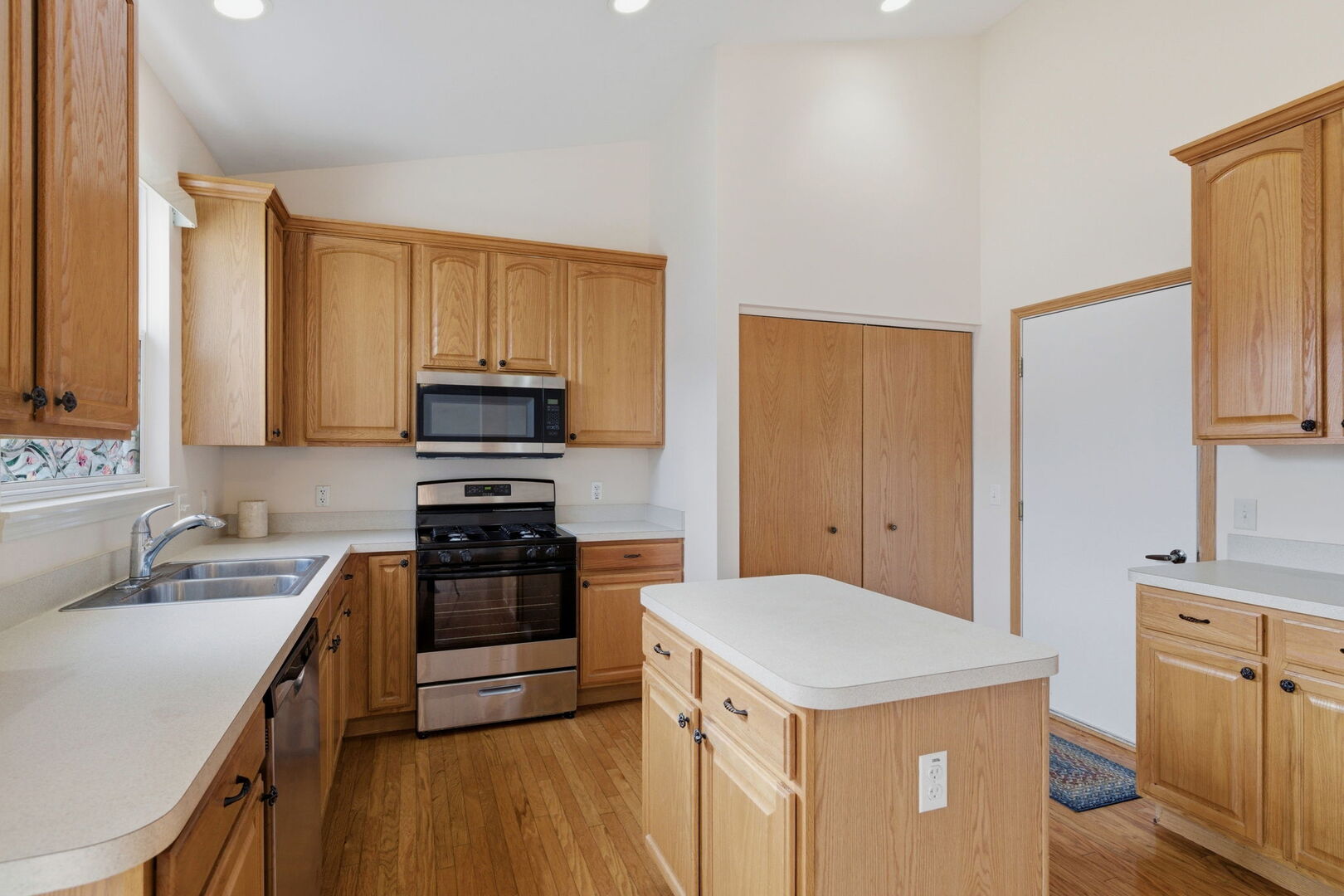 1547 Cadillac Circle Romeoville, IL 60446 - Photo 11 of 21 a kitchen with a sink a stove top oven and refrigerator