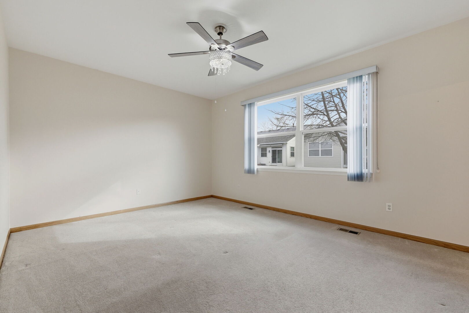 1547 Cadillac Circle Romeoville, IL 60446 - Photo 12 of 21 an empty room with windows and fan