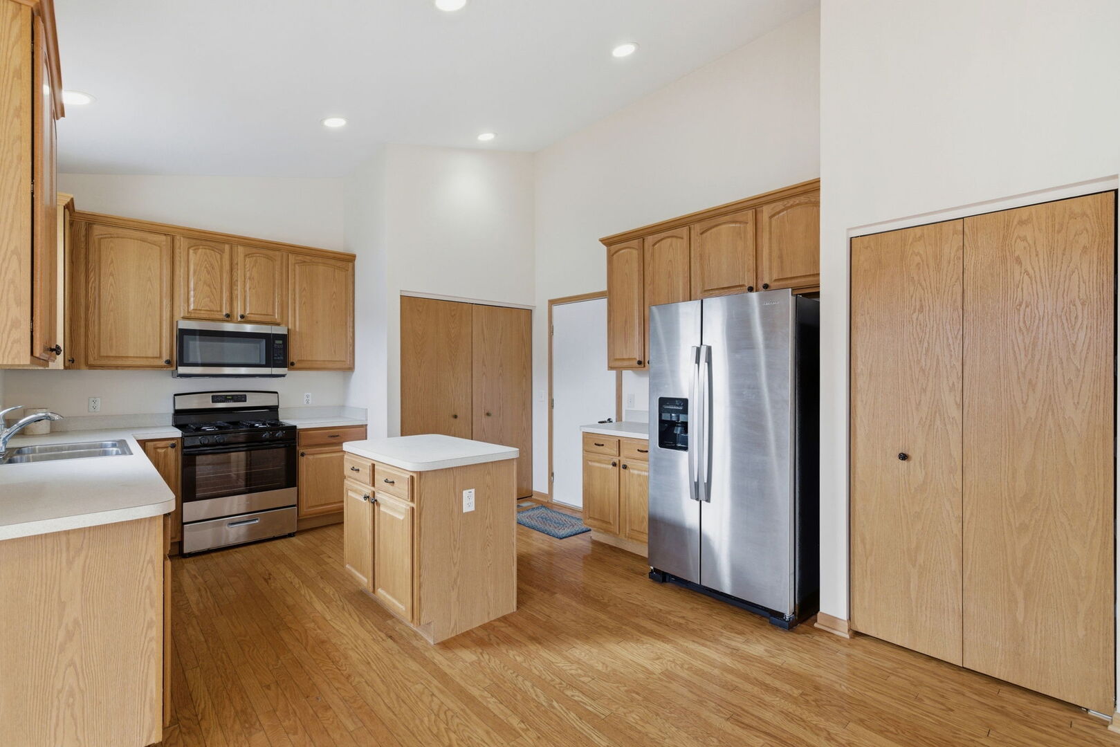 1547 Cadillac Circle Romeoville, IL 60446 - Photo 7 of 21 a kitchen with stainless steel appliances a refrigerator stove microwave and sink