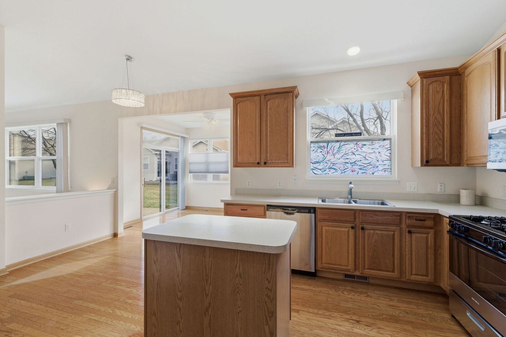 1547 Cadillac Circle Romeoville, IL 60446 - Photo 8 of 21 a kitchen with stainless steel appliances a sink stove and cabinets