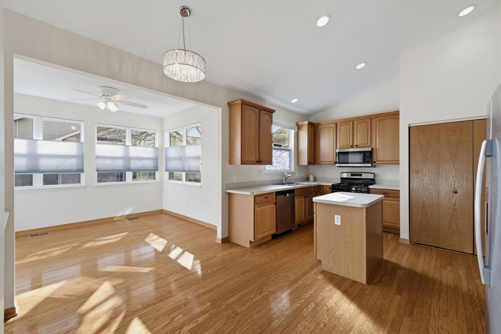 1547 Cadillac Circle Romeoville, IL 60446 - Photo 9 of 21 a kitchen with refrigerator cabinets and wooden floor