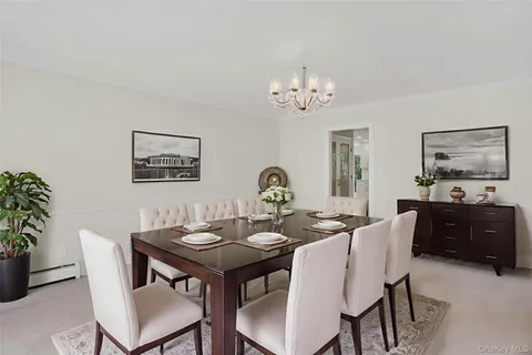 a view of a dining room with furniture and chandelier