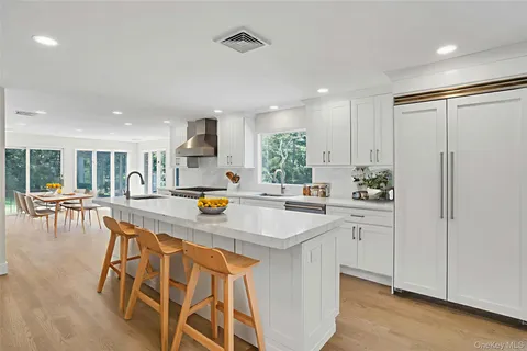 a kitchen with stainless steel appliances granite countertop a refrigerator and a sink