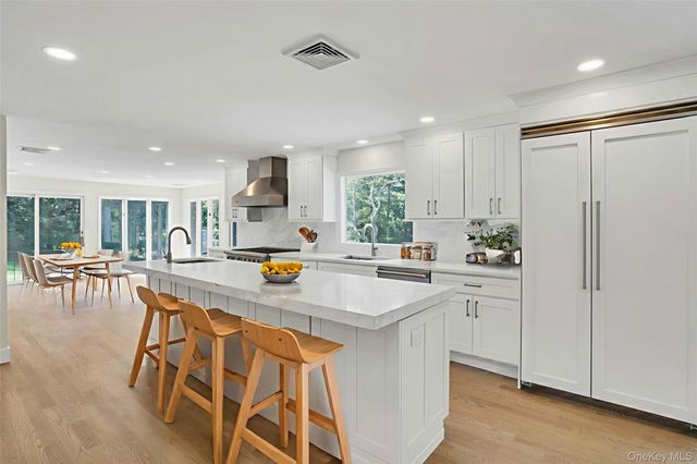 a kitchen with stainless steel appliances granite countertop a refrigerator and a sink