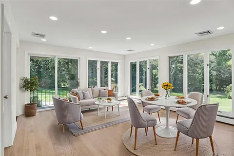 a living room with furniture and large windows