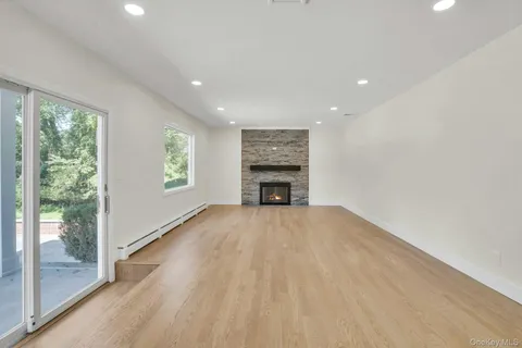 en empty room with a fireplace and windows