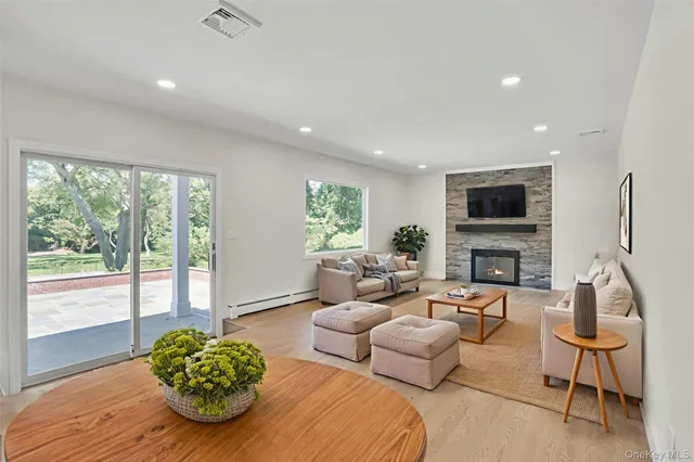 a living room with furniture a fireplace and a flat screen tv