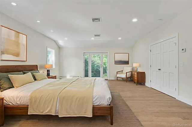 a spacious bedroom with a bed and large windows