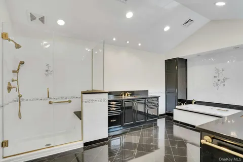 a view of kitchen with stainless steel appliances kitchen island sink stove and cabinets