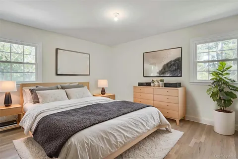 a bedroom with a bed potted plant and window