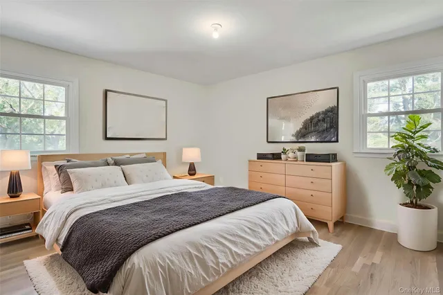 a bedroom with a bed potted plant and window