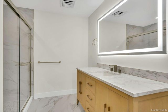 a bathroom with a sink vanity and a mirror