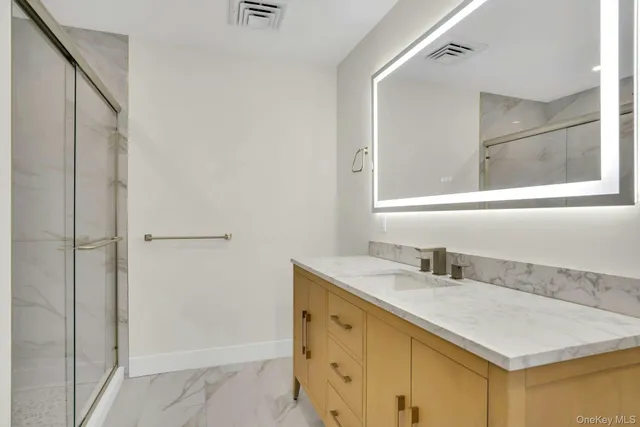 a bathroom with a sink vanity and a mirror