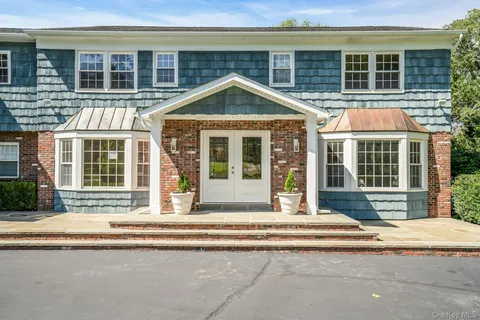 a view of a brick house with large windows