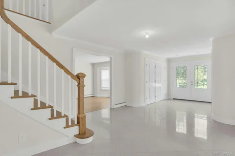 a view of an entryway with wooden floor