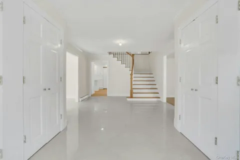 a view of a hallway with stairs and a window
