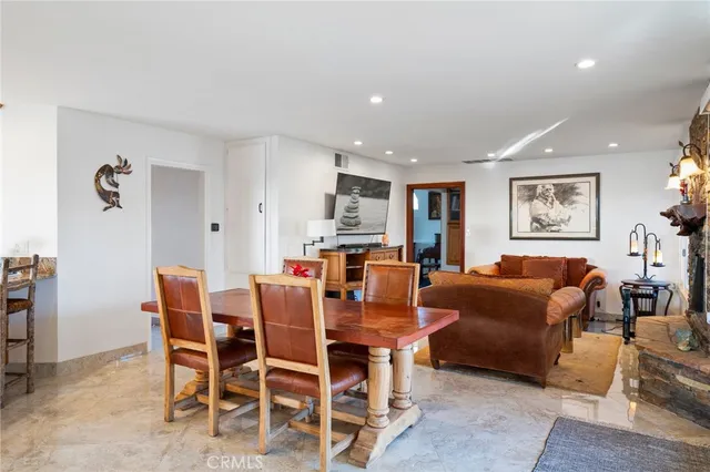a living room with furniture a dining table and kitchen view