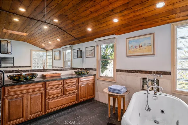 a kitchen with stainless steel appliances granite countertop a sink a stove a counter space and cabinets