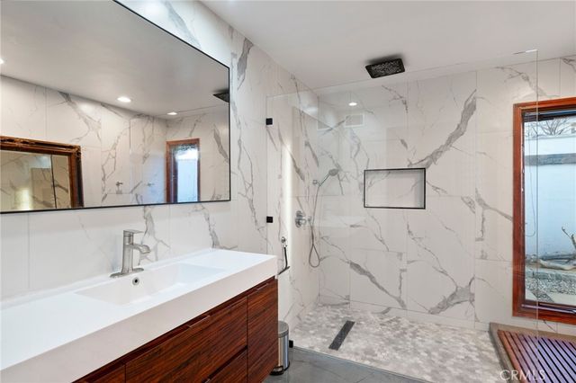 a bathroom with a granite countertop sink a toilet and a mirror