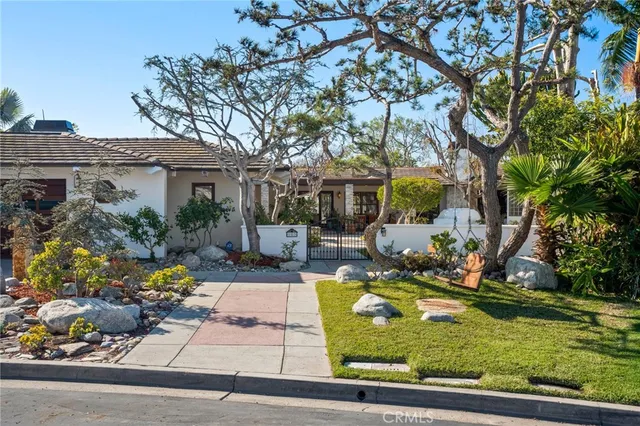 a view of a house with backyard outdoor seating and trees