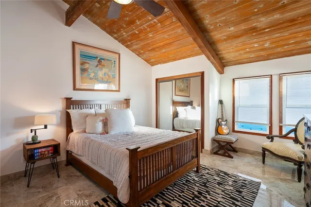 a bedroom with a bed a table and chair